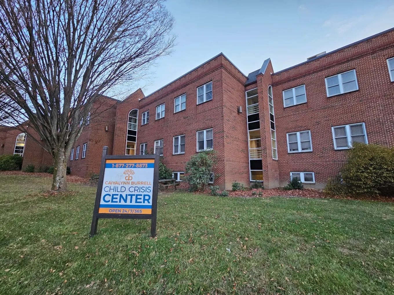 Brick Child Crisis Center building with facility sign and lawn