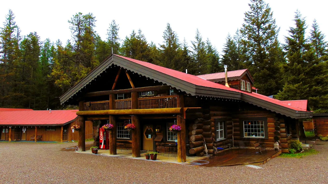 Rustic log lodge at Recovery Centers of Montana in Columbia Falls, surrounded by evergreen trees