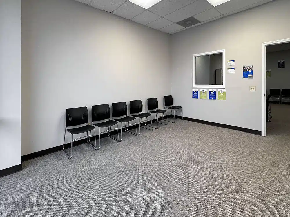 Waiting area with chairs and check-in window at treatment center