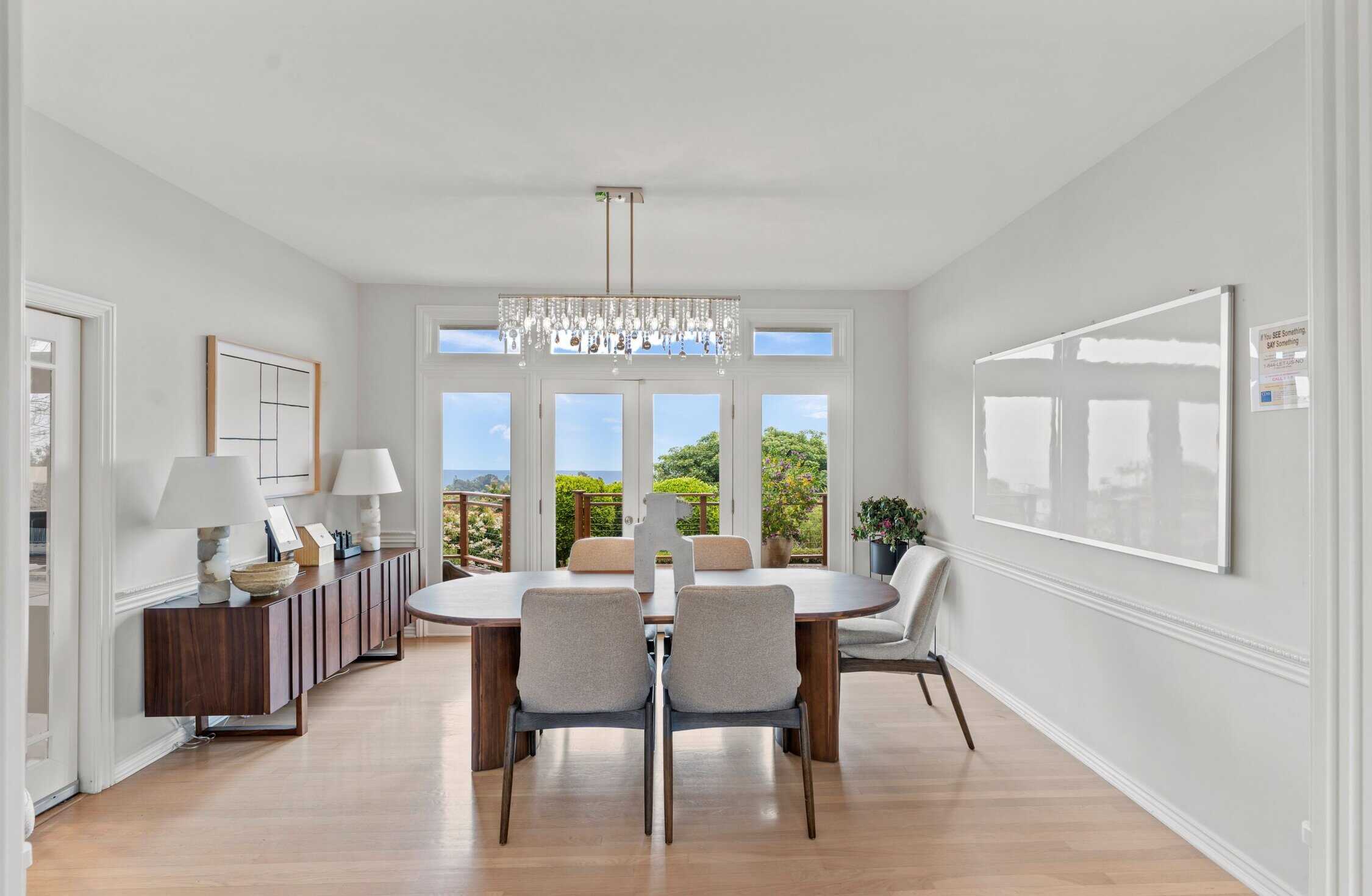 Bright dining room with ocean-view balcony access