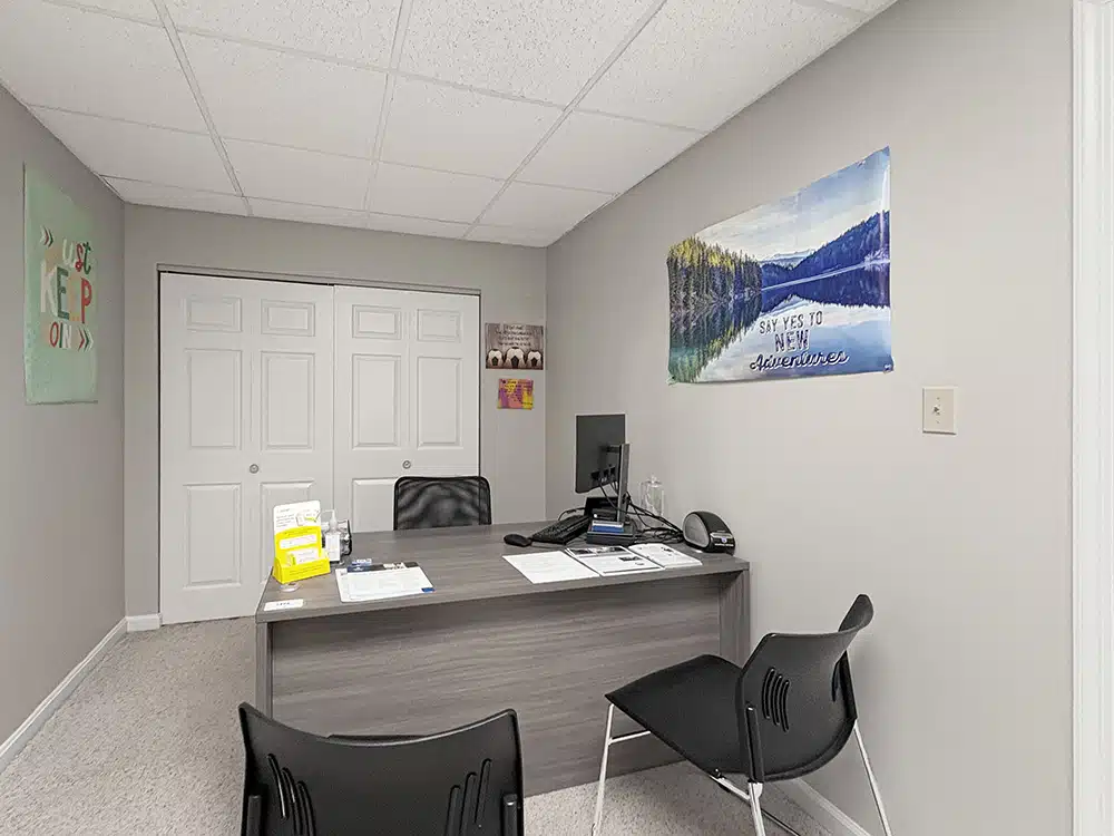 Private office with desk, computer, and guest chairs