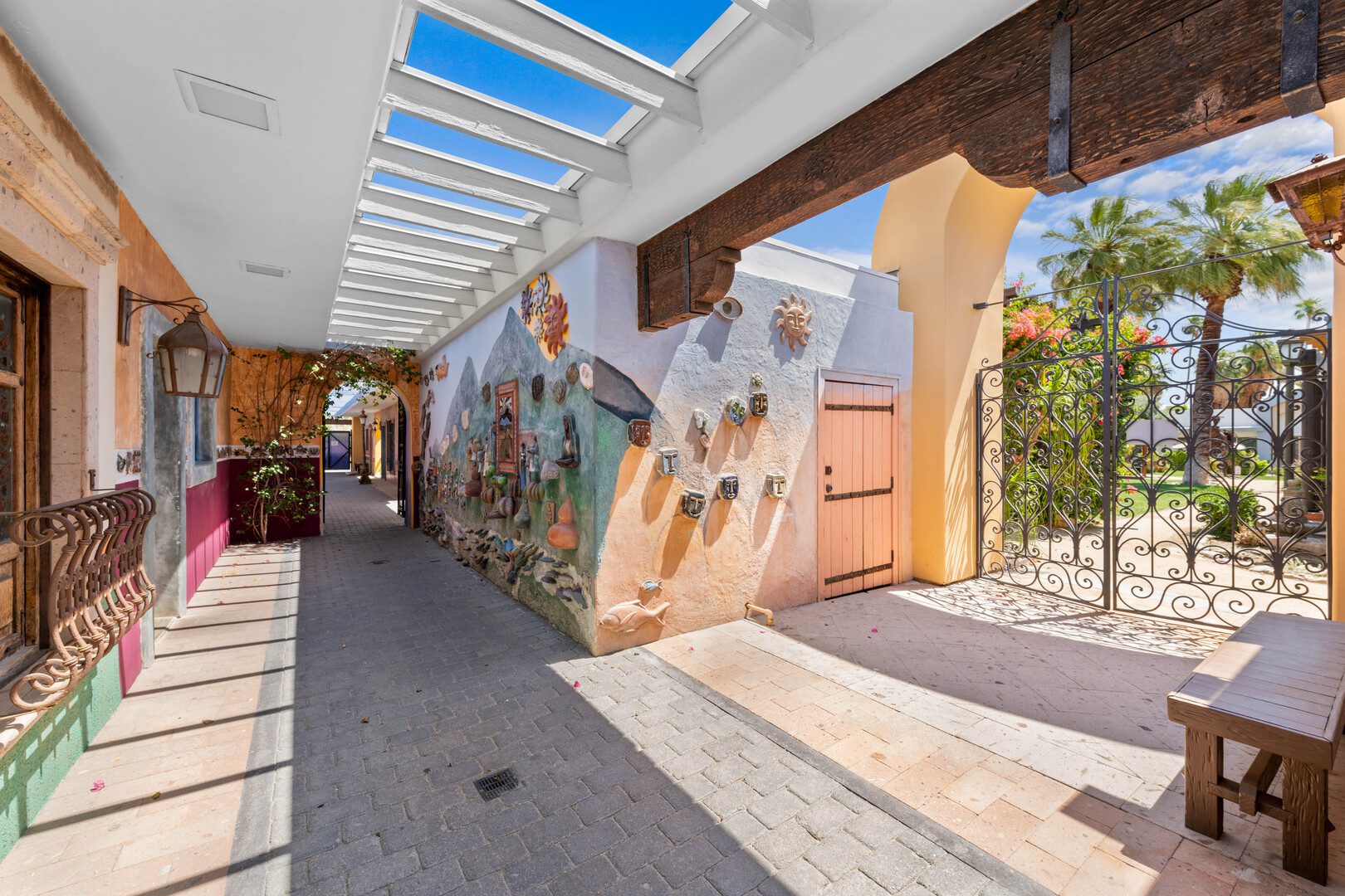 Covered walkway with colorful murals and courtyard access
