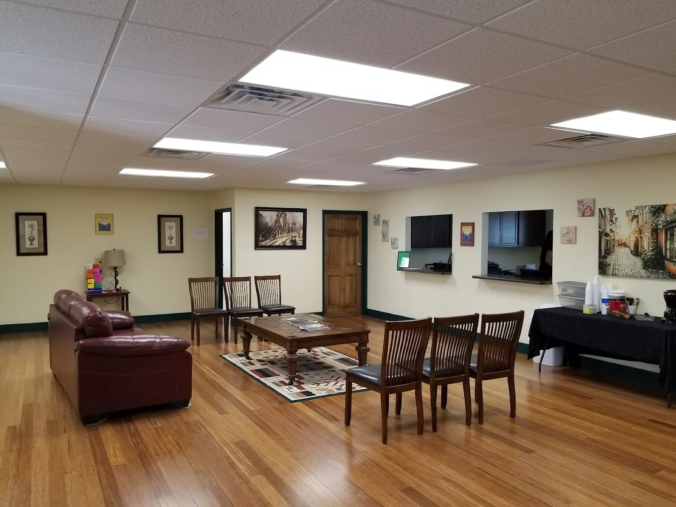 Waiting area with couch, chairs, and reception windows