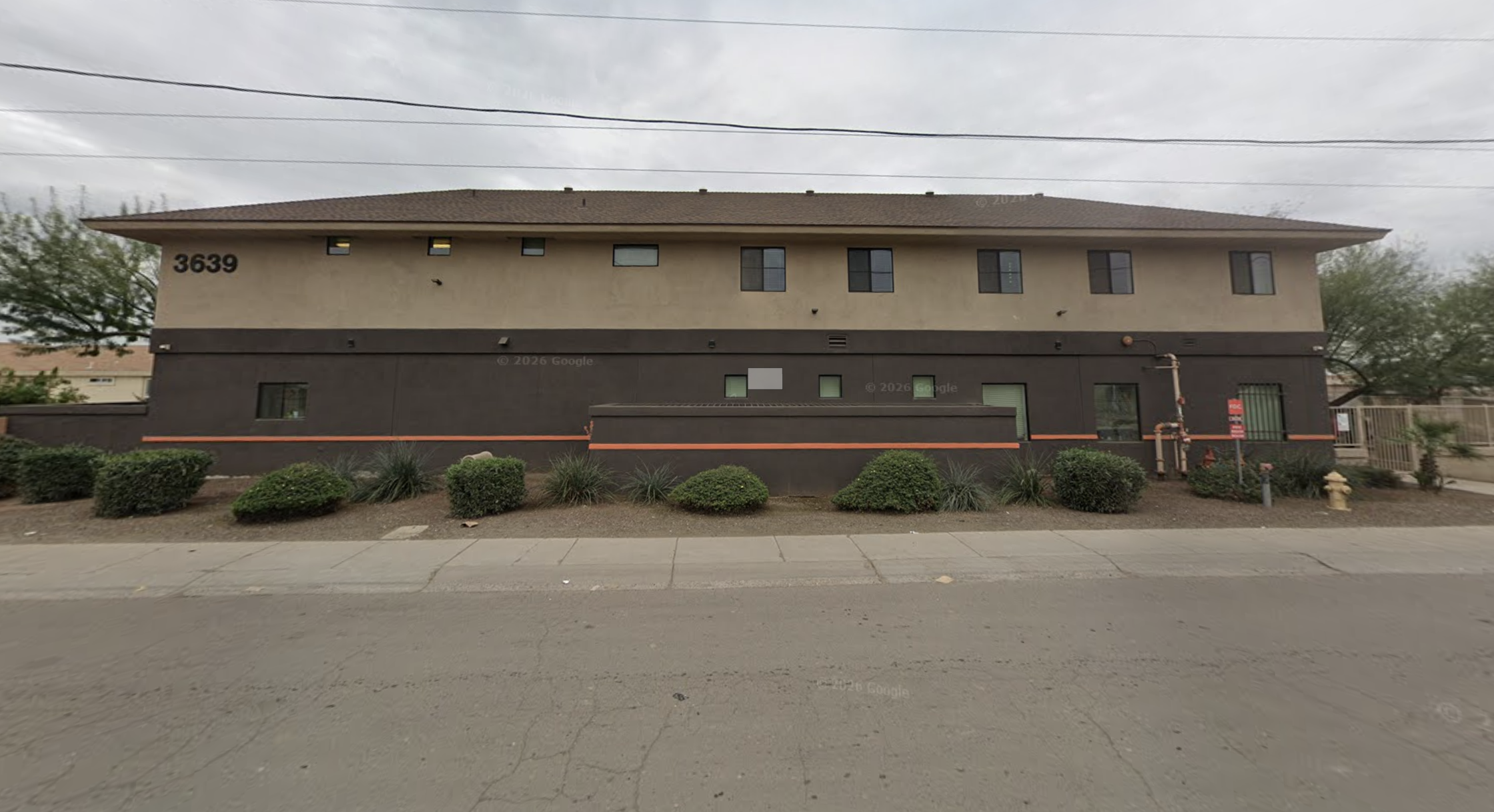 Two-story treatment center with shrubs along the exterior