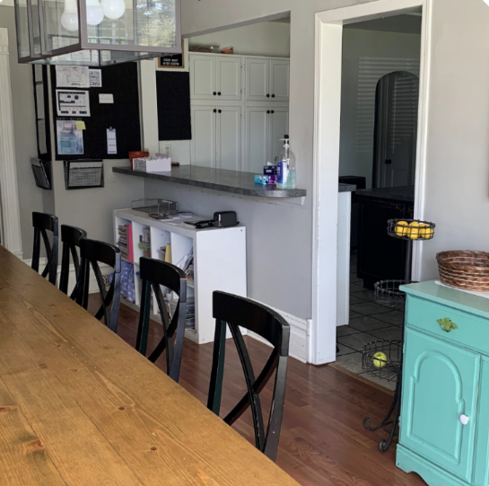 Rehab kitchen with long dining table and modern decor