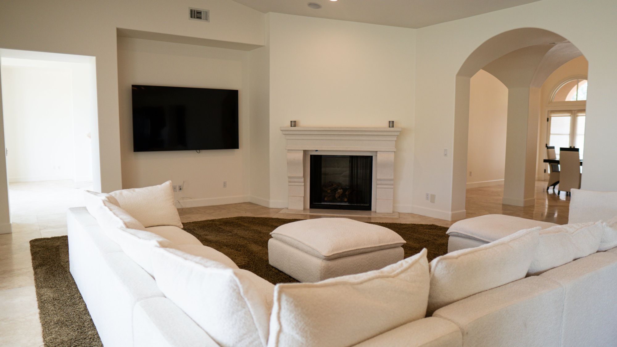 Bright living room with fireplace and oversized sectional