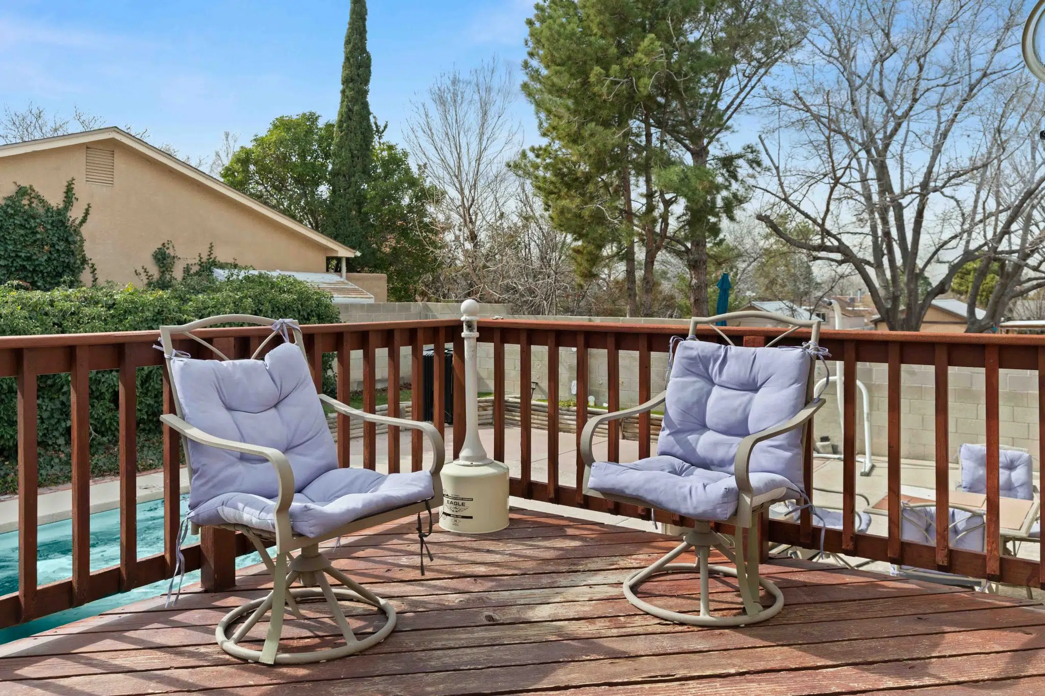 Outdoor deck with cushioned seating overlooking the yard