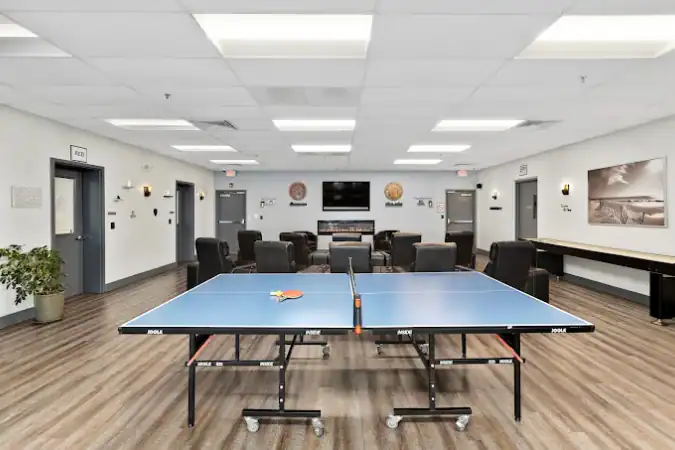Ping-pong table in recreation room with lounge seating