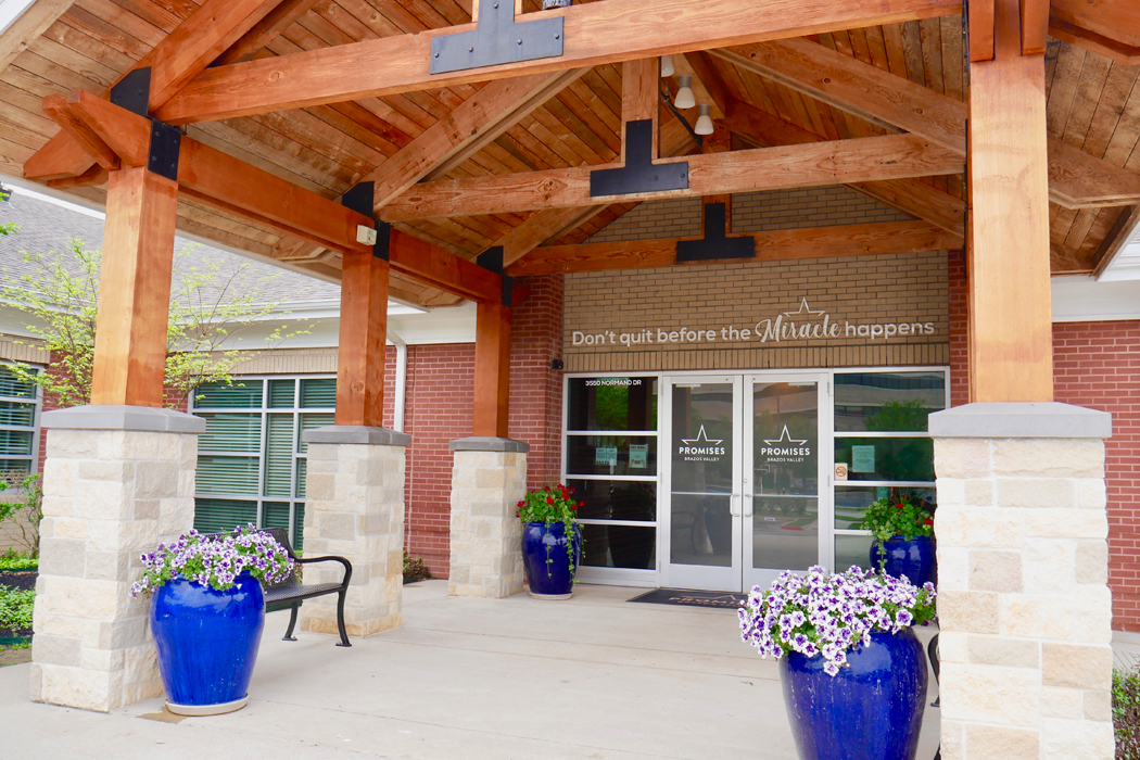 Facility entrance with covered walkway and seating