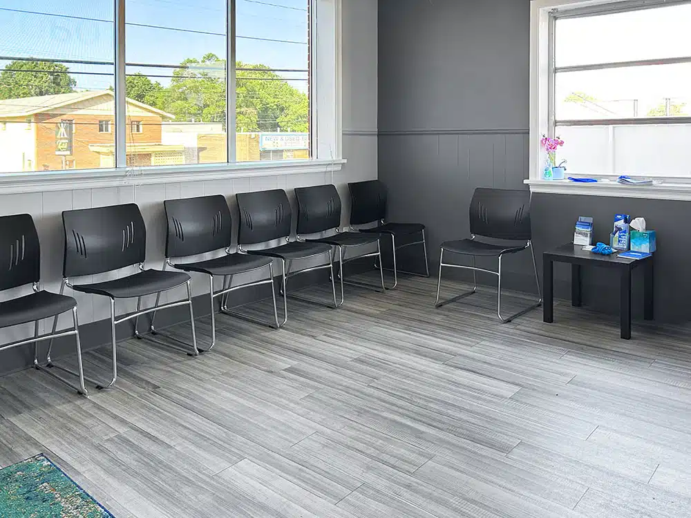 Waiting area with chairs and large windows at treatment center