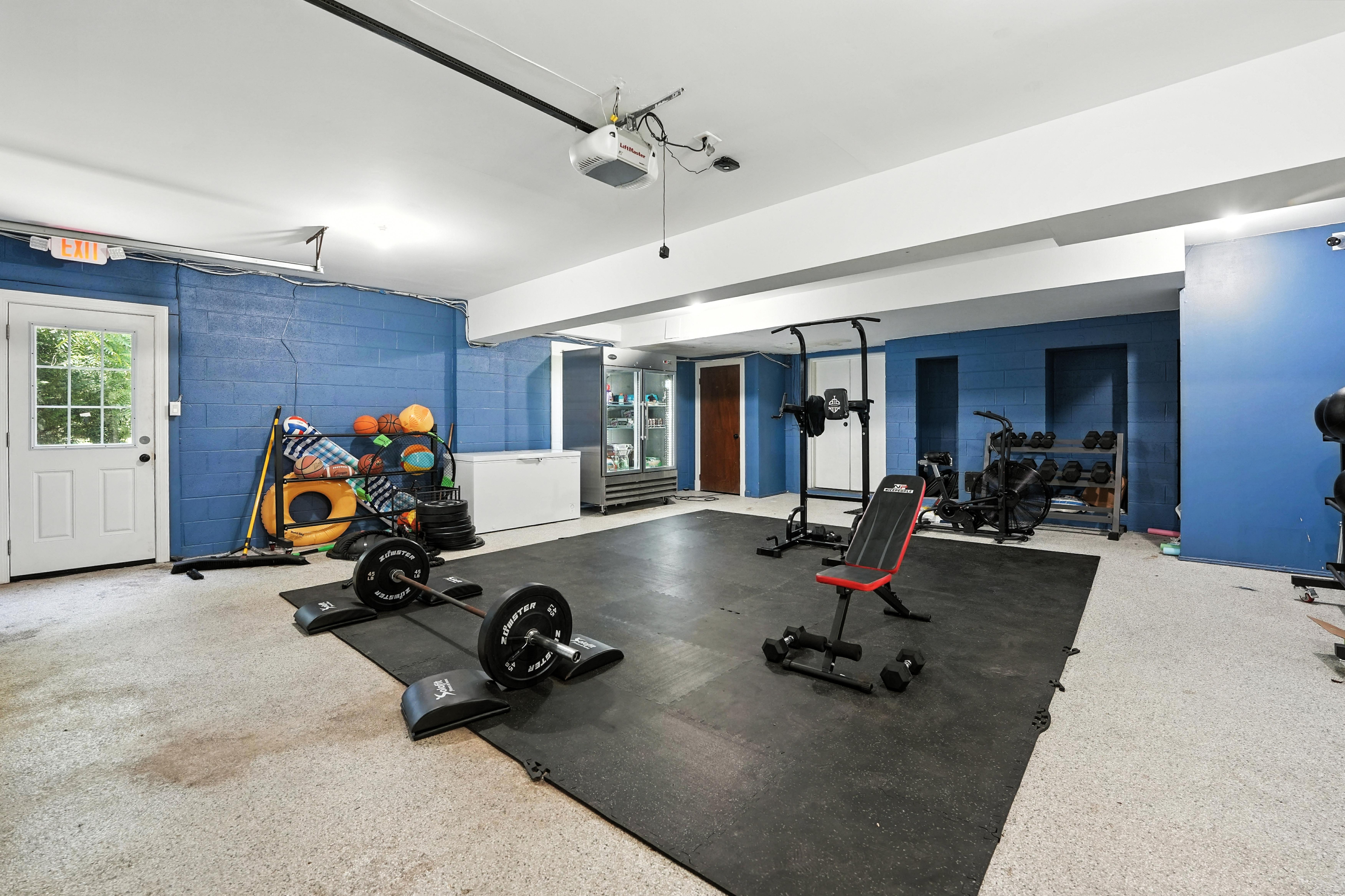 Gym space with weights, bench, and exercise equipment