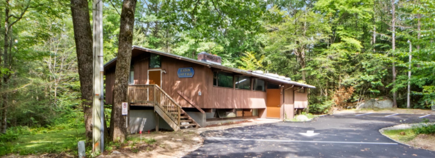 Building with trees and a paved driveway.