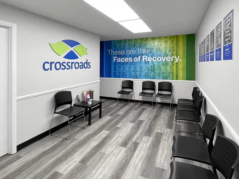 Waiting area with chairs and Faces of Recovery wall