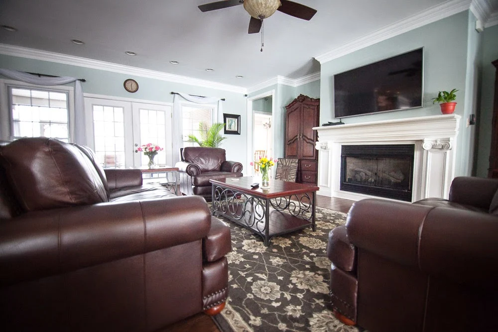 Shared living room with couches, fireplace, and communal seating
