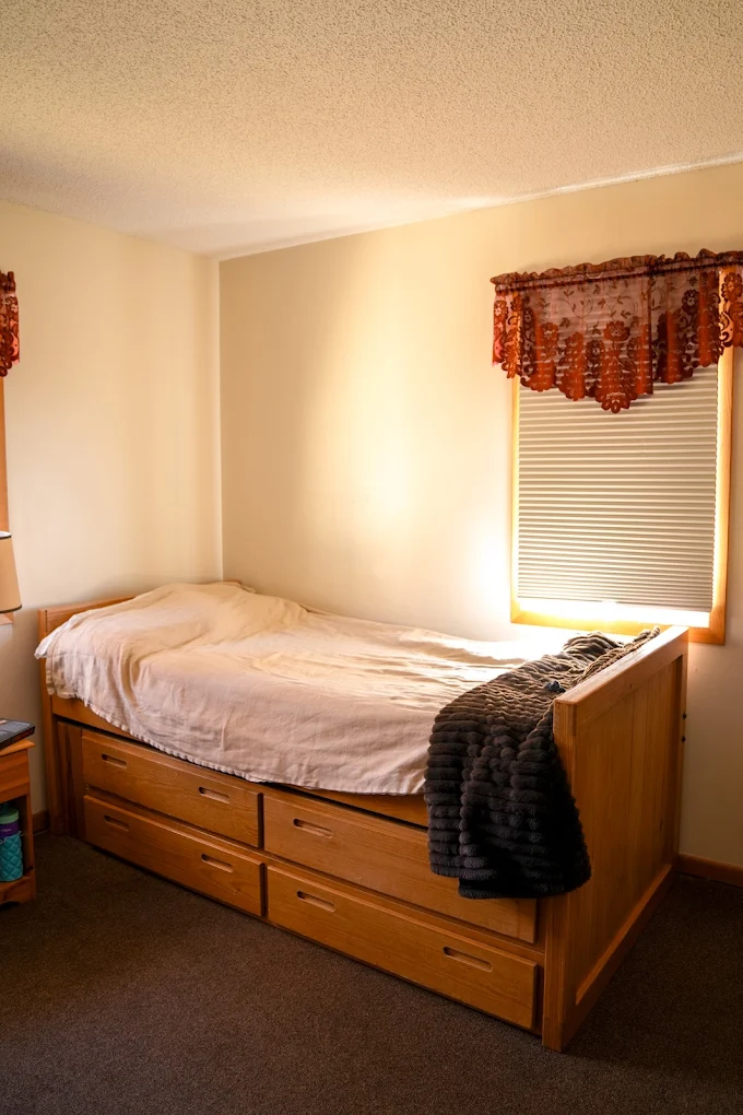 Simple bedroom with twin bed and built-in storage