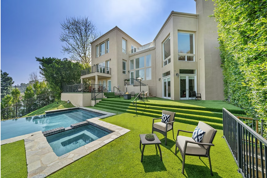 Modern hillside rehab home with balconies and large windows