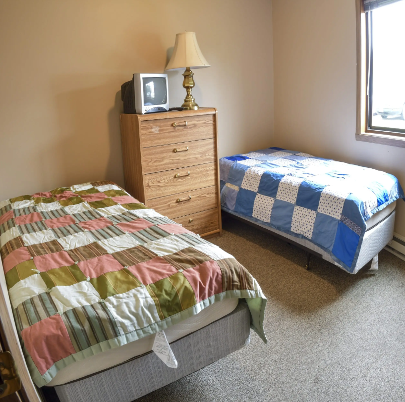 Shared bedroom with two twin beds and dresser