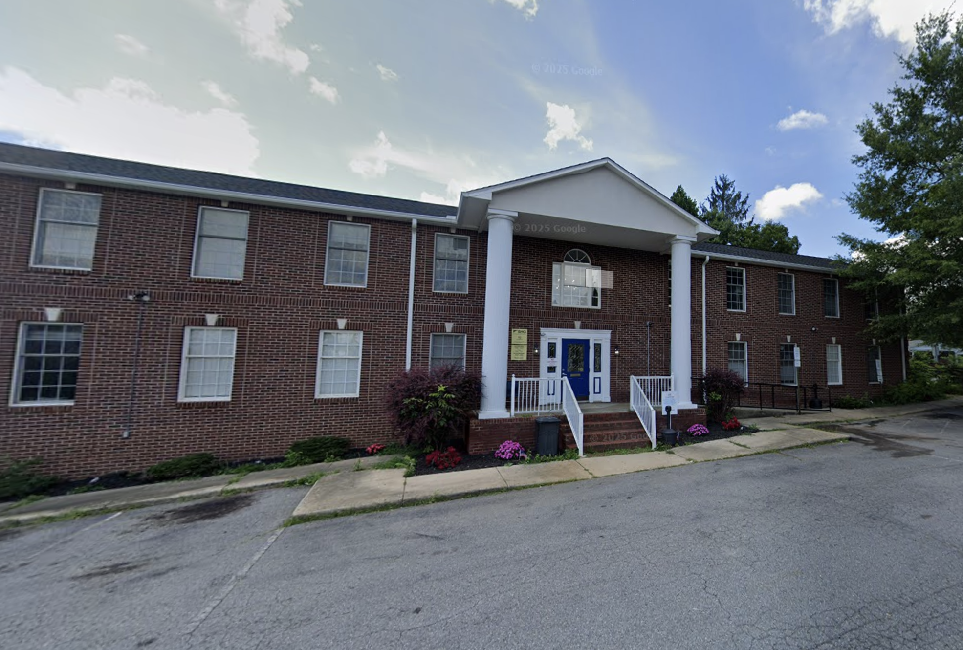 Brick exterior of BHG Asheville Treatment Center with entrance columns