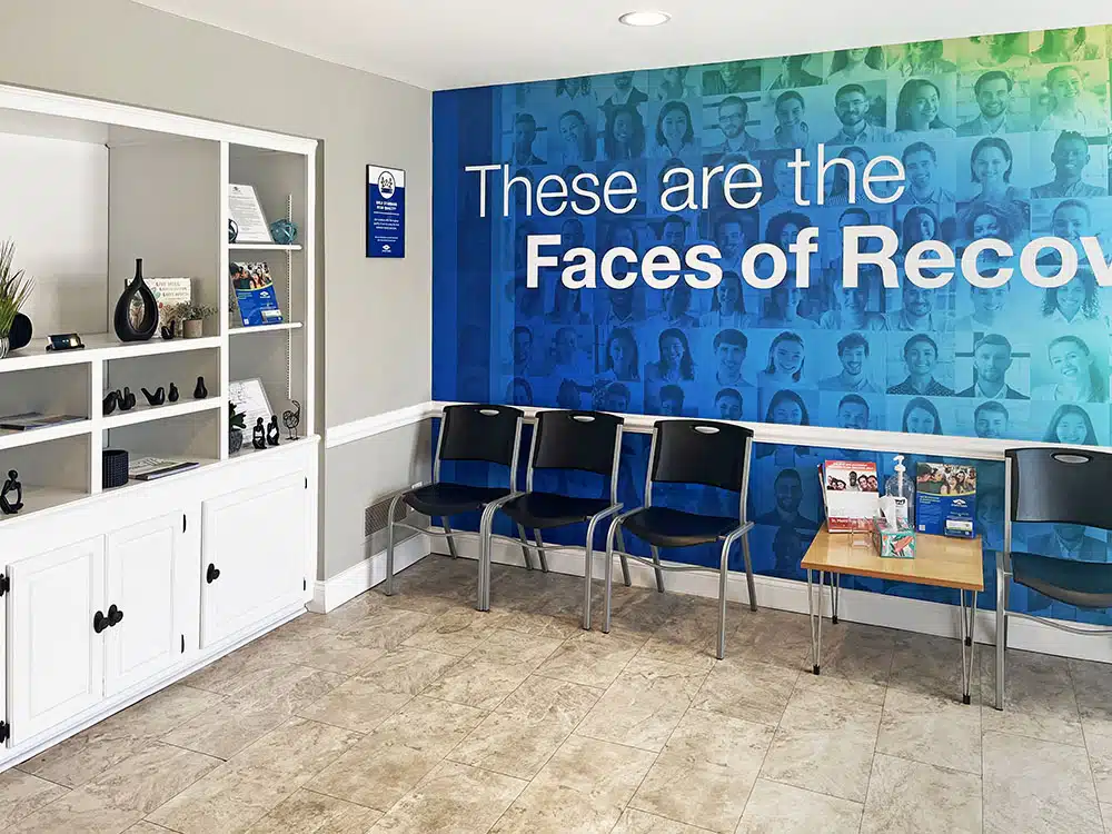 Waiting area with chairs and Faces of Recovery wall mural