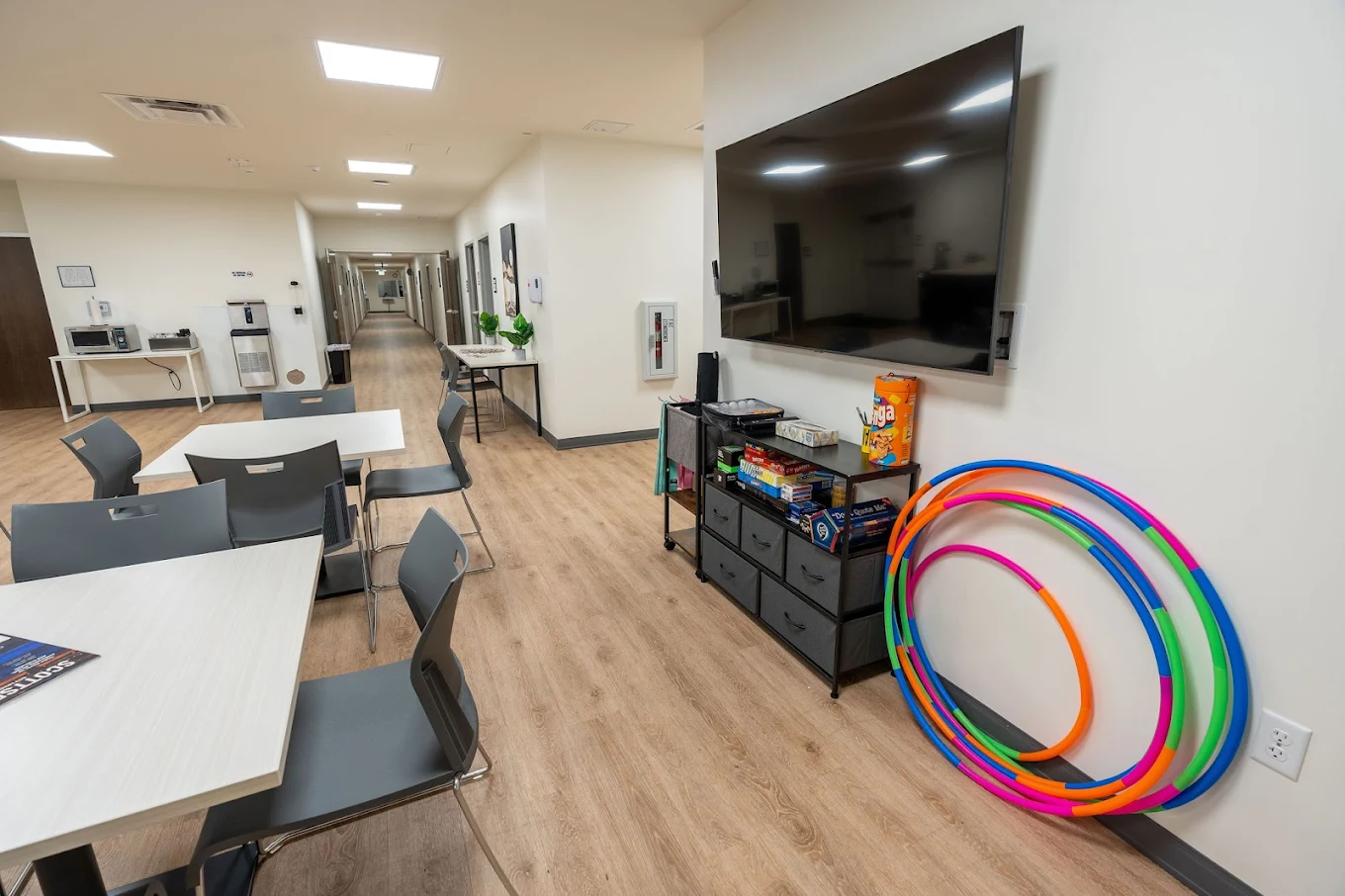 Recreation area with tables, TV, and activity supplies