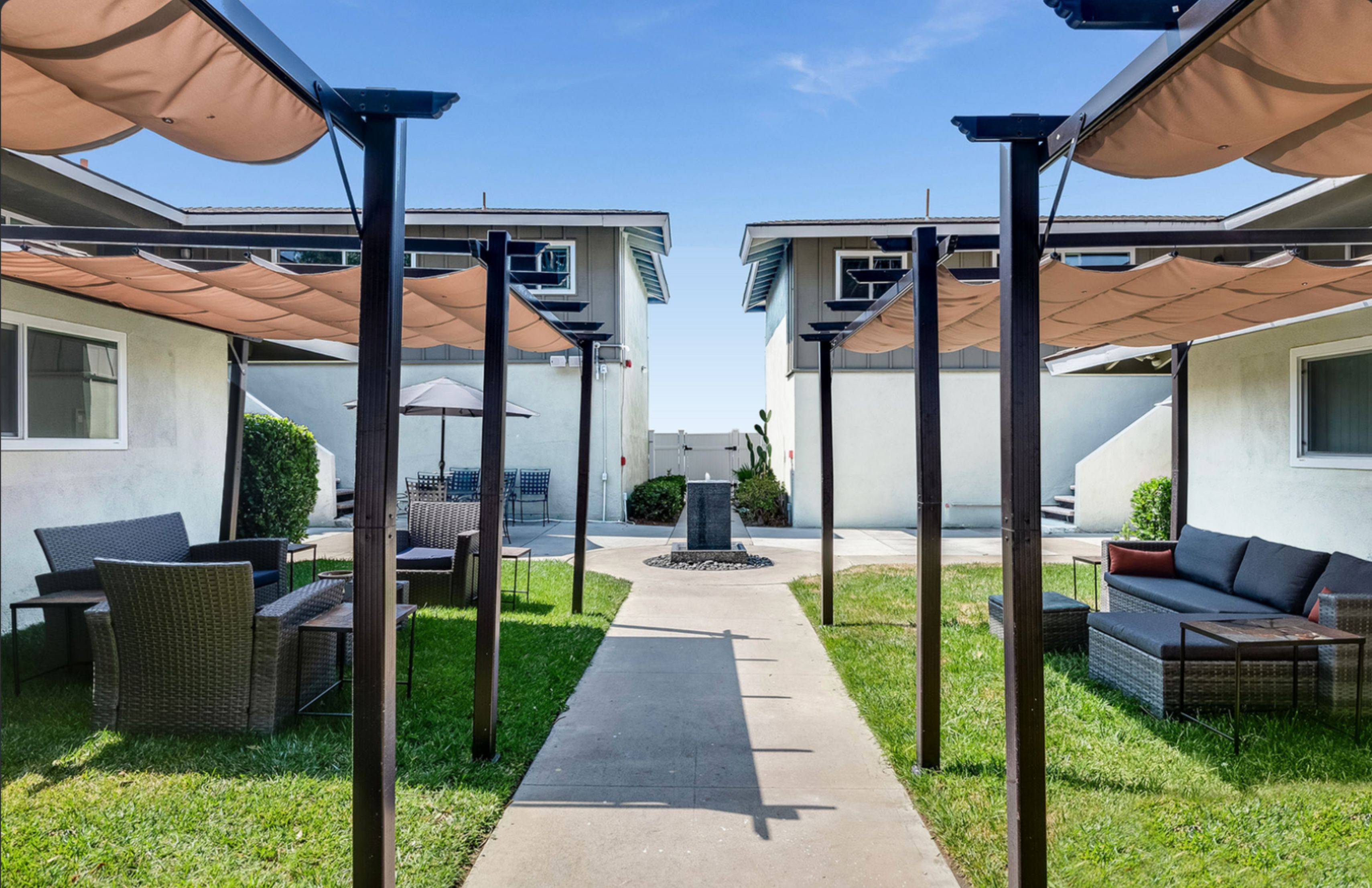 Courtyard with shaded seating and a central water feature.