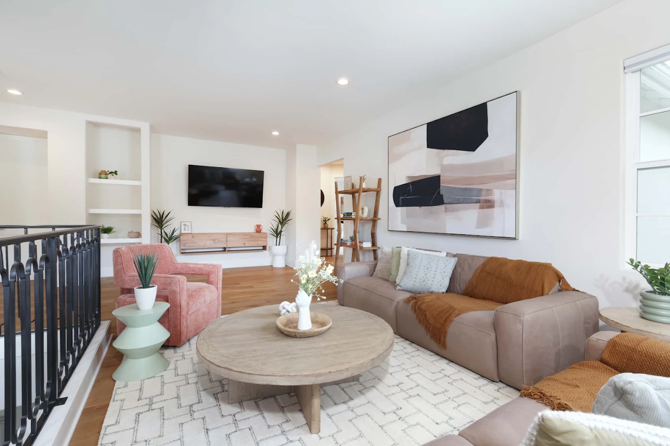 Comfortable lounge with sofas, chairs, and wall-mounted TV