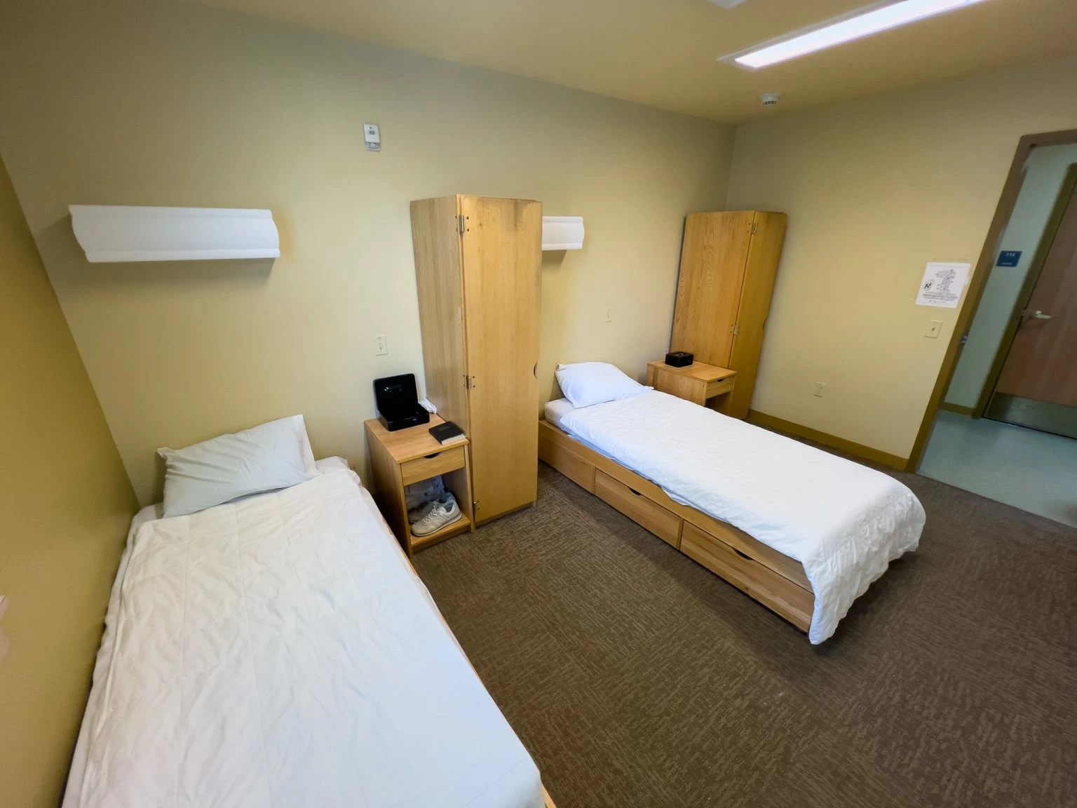 Two twin beds with storage and wooden furniture