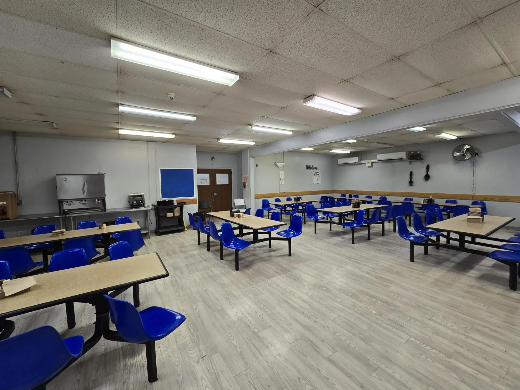 Spacious dining area with blue molded chairs