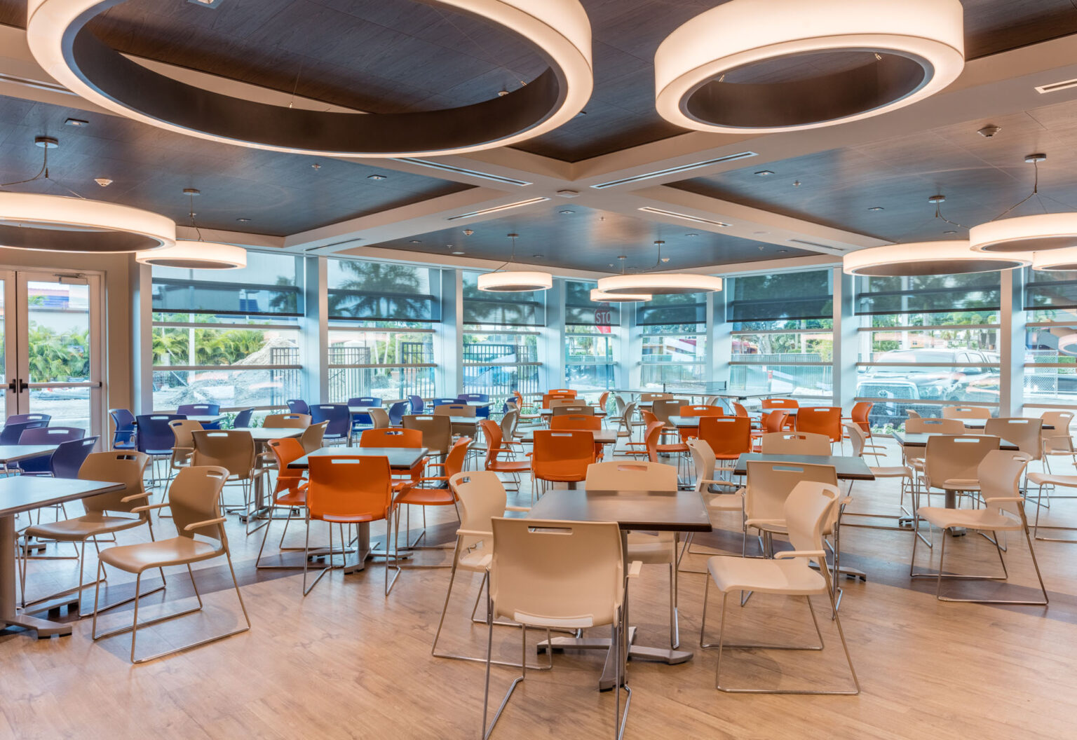  Dining space with colorful chairs and large windows