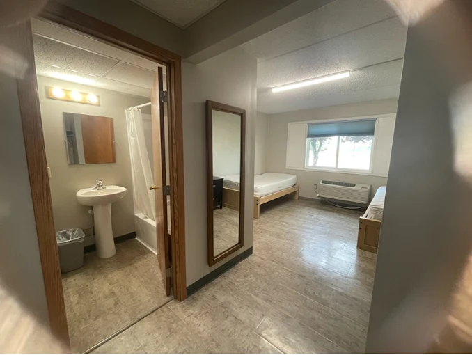 Bright patient room with twin beds and private bath