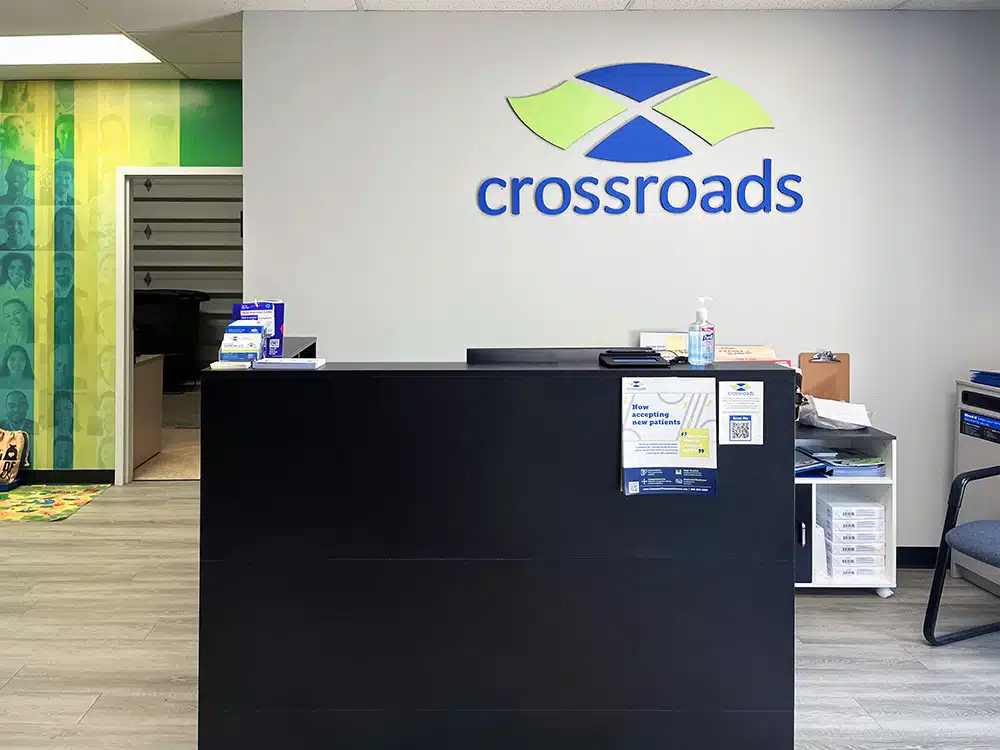 Front desk with Crossroads logo and patient check-in area