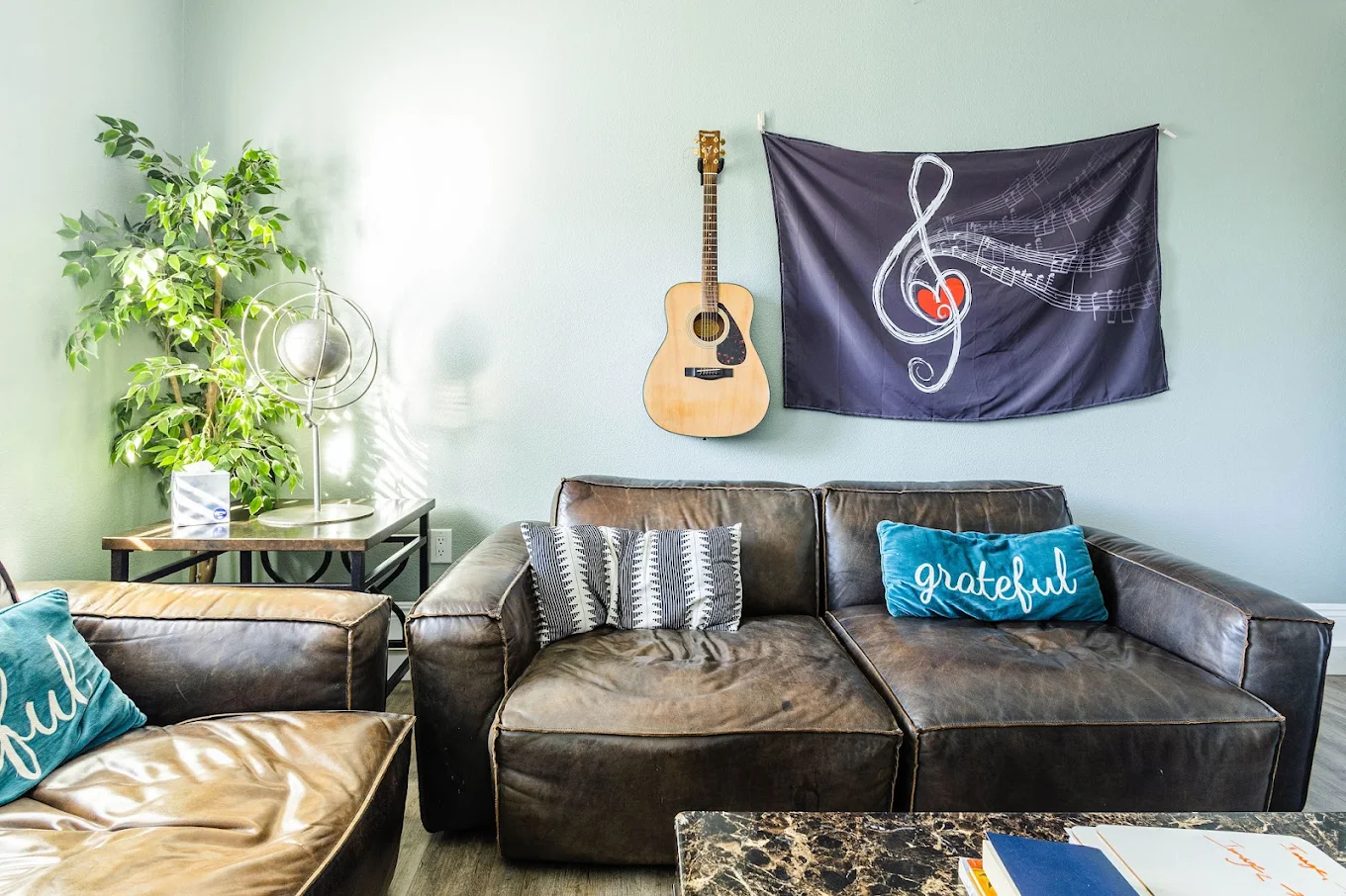 Couch with guitar and music-themed wall decor