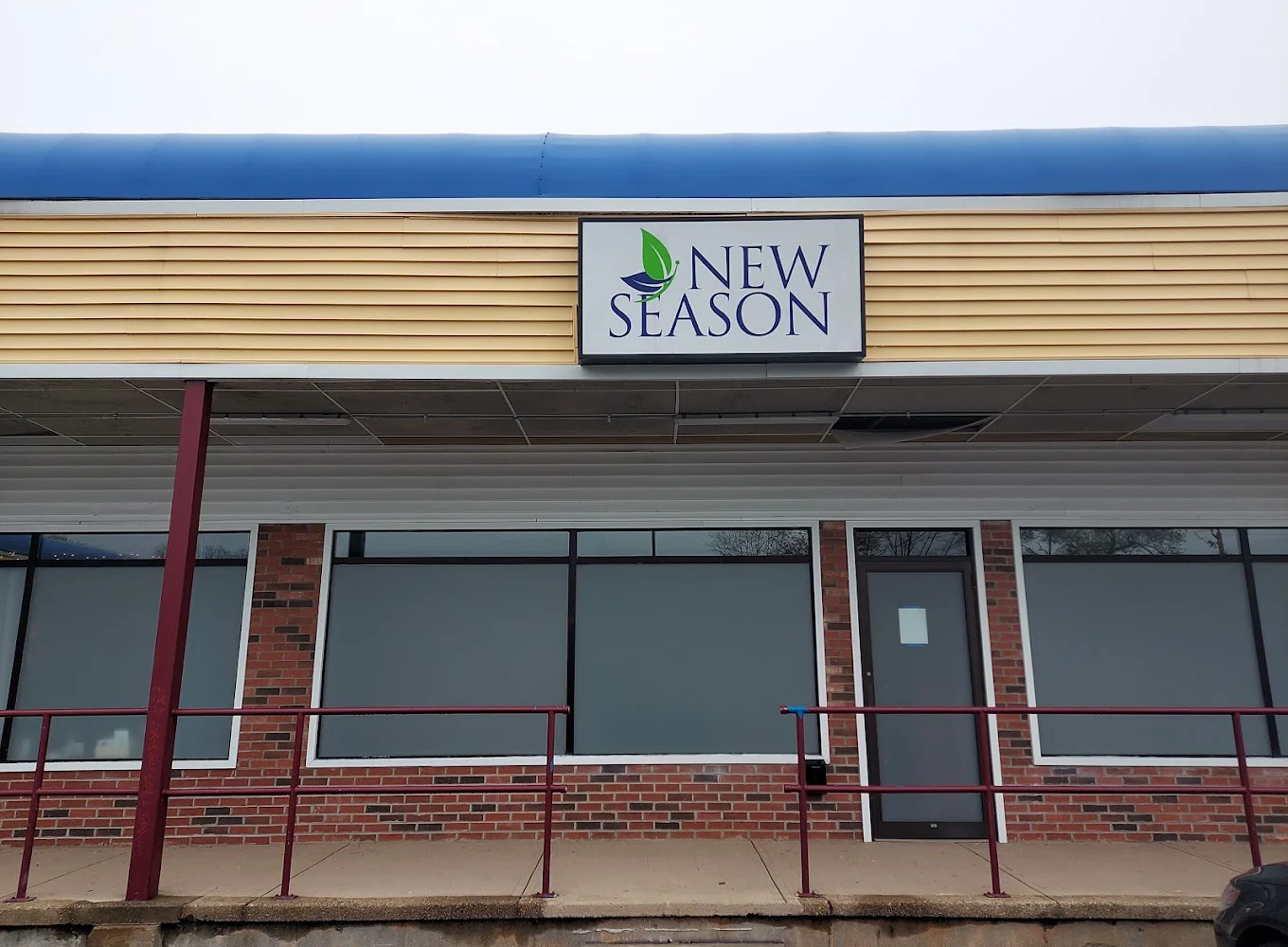 New Season storefront with brick exterior and entrance ramp