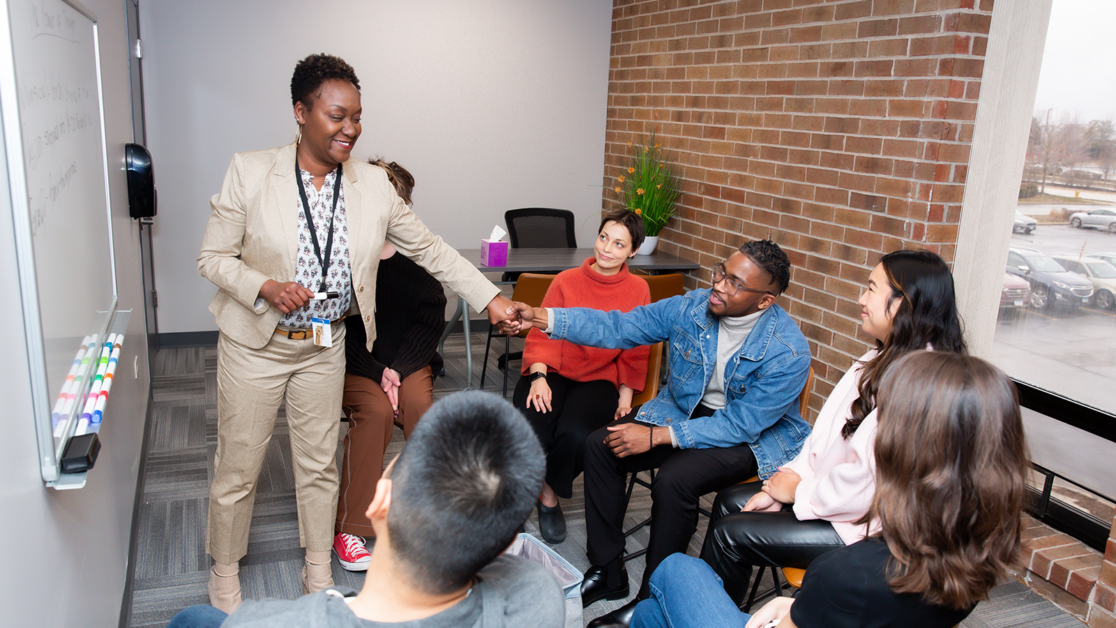 Mini-classroom with people behind a whiteboard.