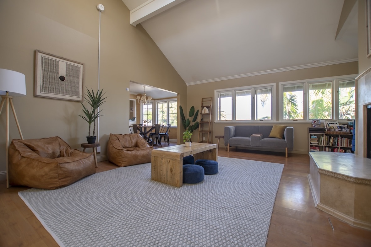 A spacious living area with bean bags and modern decor.