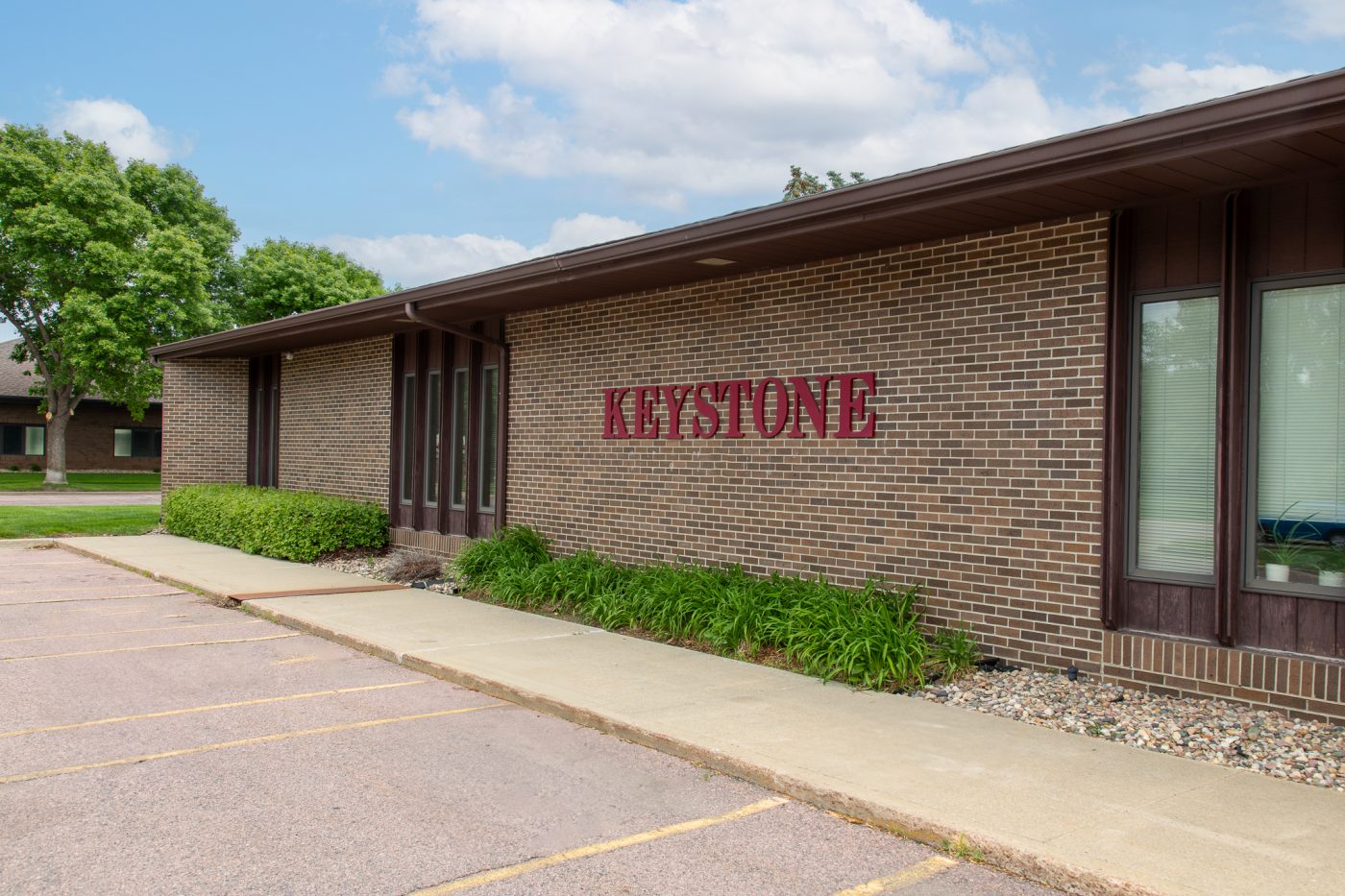 Exterior view of Keystone Treatment Center brick building with parking area and landscaped walkway