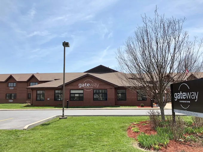 Main entrance with Gateway Foundation sign and sidewalk