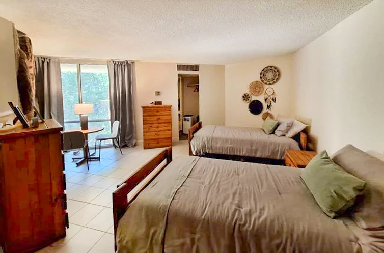 Shared bedroom with two beds and simple furnishings