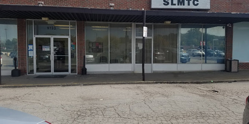  Exterior view of a well-maintained brick building with large windows, offering a welcoming entrance for visitors and clients.