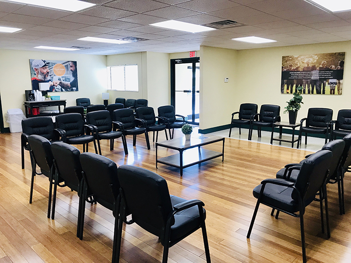 Group therapy room with chairs in circle and coffee table
