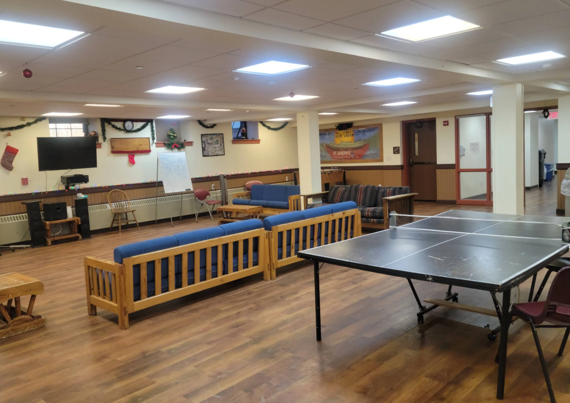 Indoor lounge with sofas, ping pong table, and TV