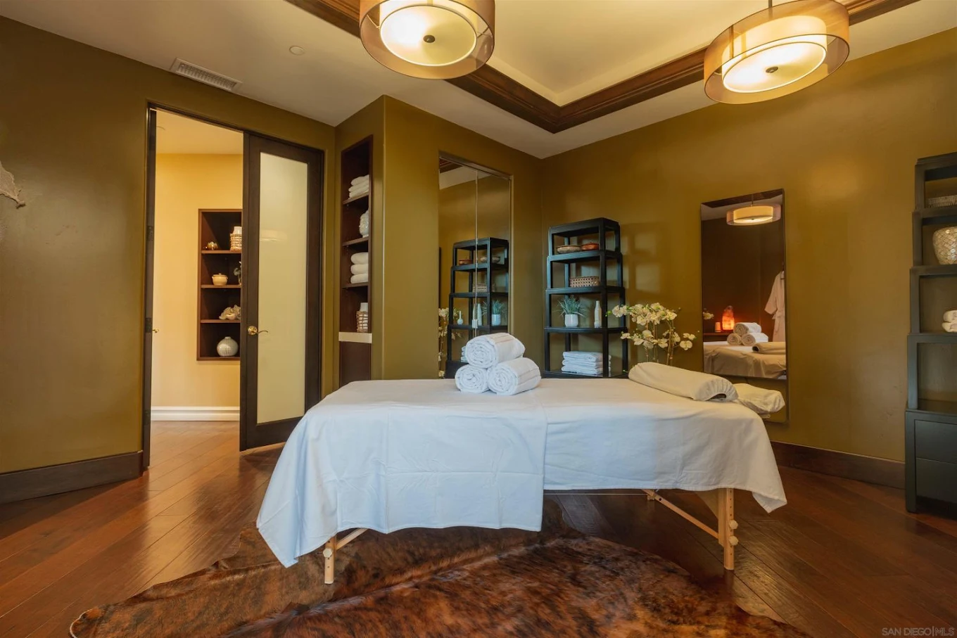 Massage table in warm, softly lit spa room