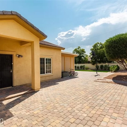 Spacious backyard with lawn, patio, and basketball hoop