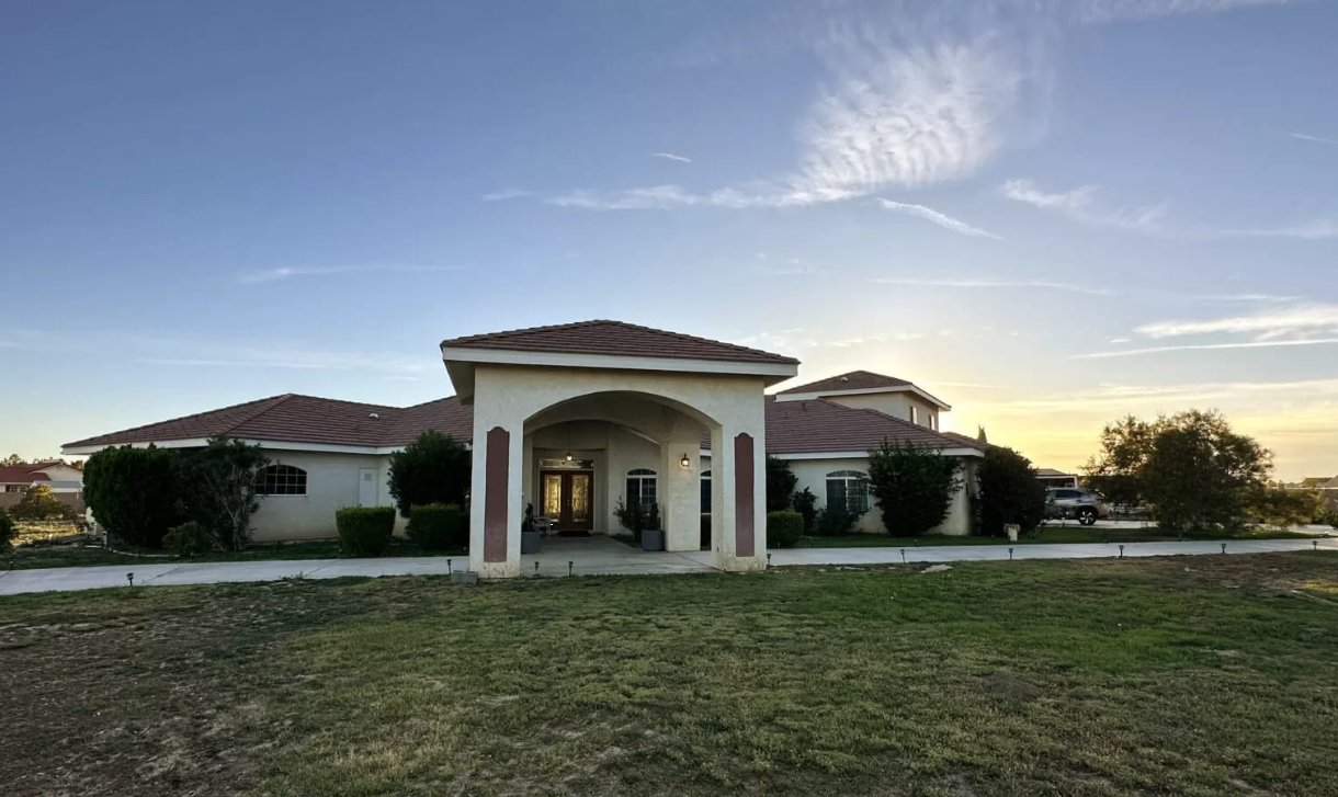 Front view of rehab facility with covered entry and driveway