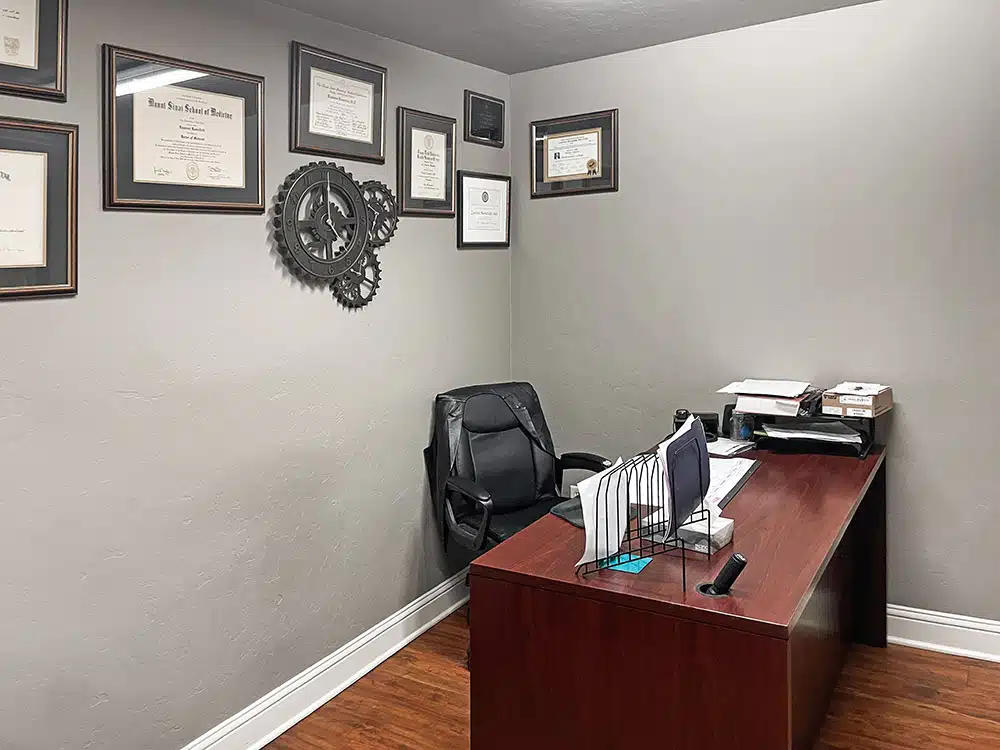 Counseling office with desk, chair, and framed certificates