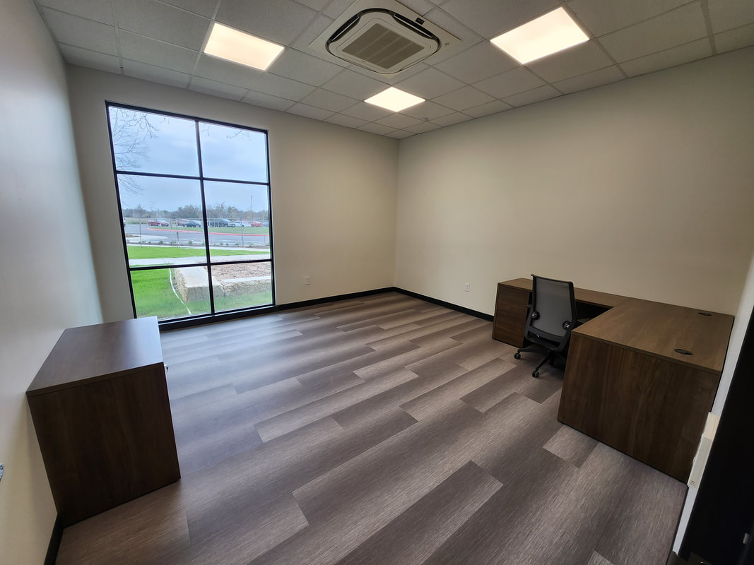 Office with large window, desk, and chair