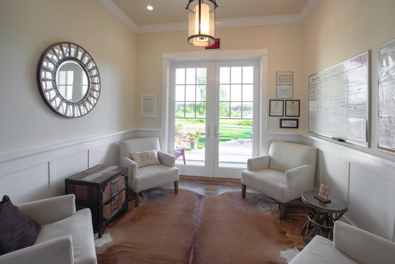 Waiting area with armchairs and side-tables.