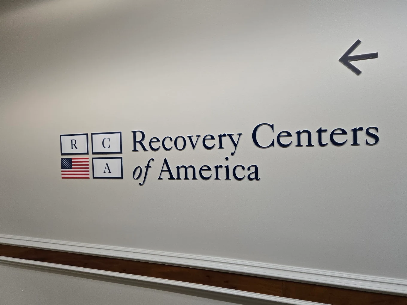 Recovery Centers of America logo displayed on an interior wall