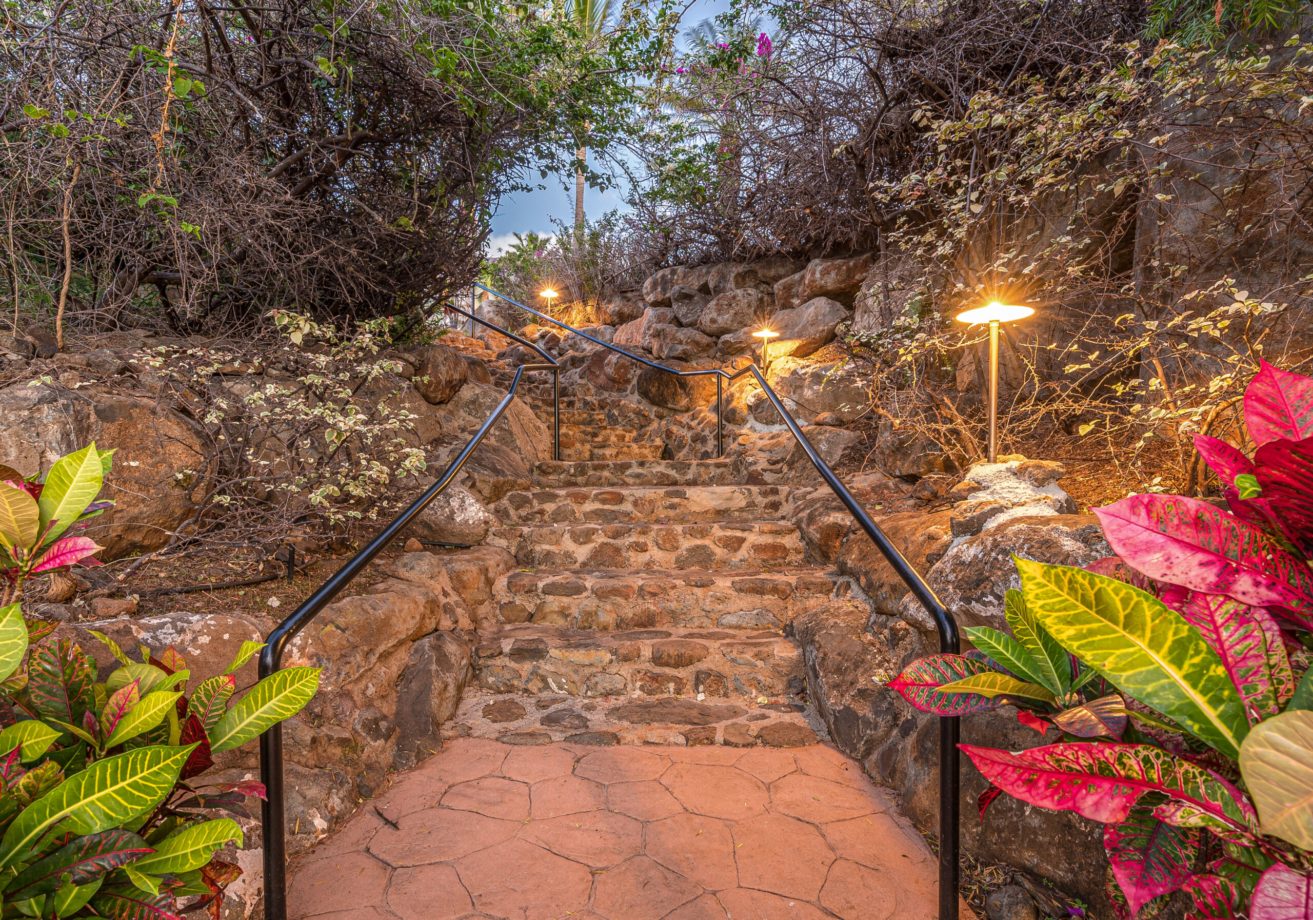 Landscaped stone stairway connecting outdoor areas through tropical gardens