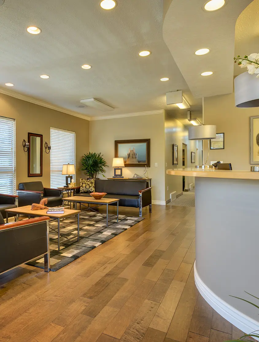 Reception area with seating and wood flooring.